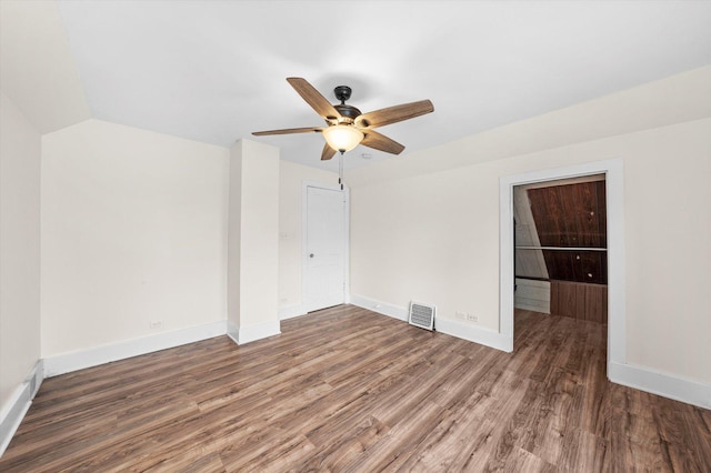 unfurnished room featuring dark wood-type flooring, ceiling fan, and lofted ceiling