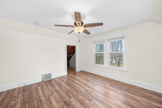 unfurnished room with hardwood / wood-style floors, ceiling fan, and vaulted ceiling