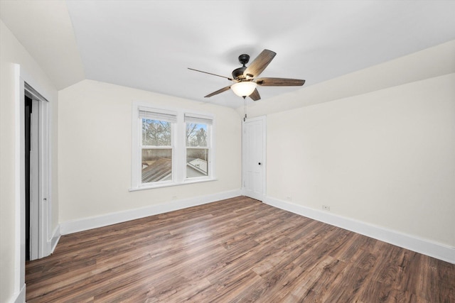 unfurnished bedroom with ceiling fan, dark wood-type flooring, and lofted ceiling