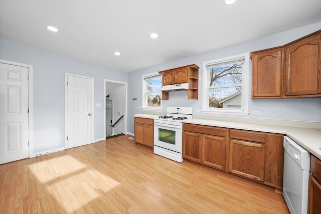 kitchen with light hardwood / wood-style flooring and white appliances