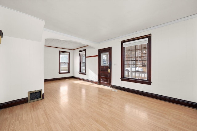 spare room featuring light hardwood / wood-style floors and ornamental molding