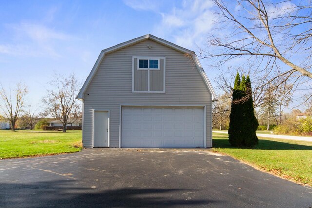 view of property exterior with a lawn and an outdoor structure