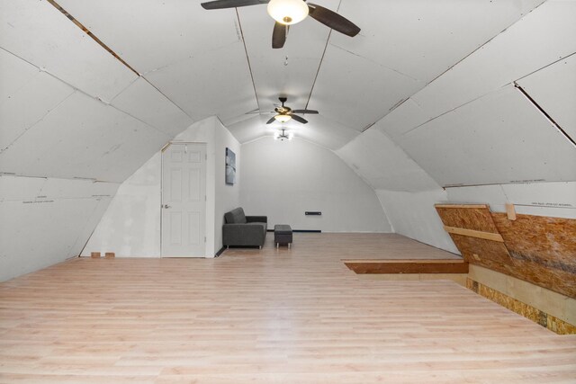 bonus room with ceiling fan, light hardwood / wood-style flooring, and vaulted ceiling