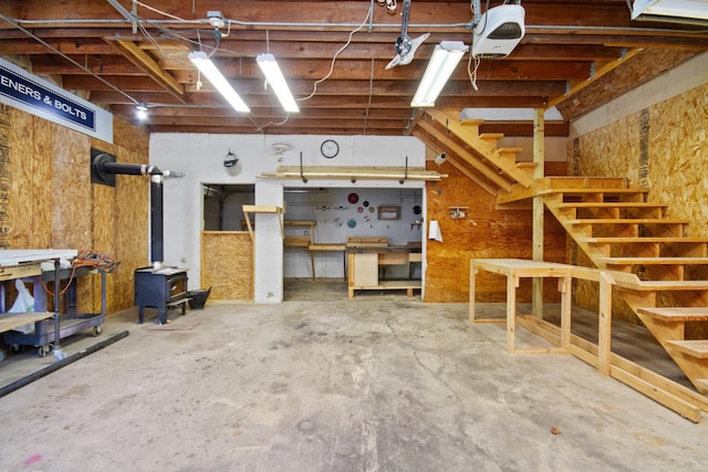 basement with a workshop area and a wood stove