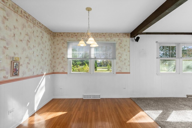 unfurnished room with beam ceiling, light hardwood / wood-style floors, and an inviting chandelier