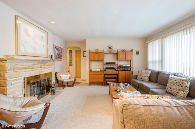 carpeted living room with a fireplace