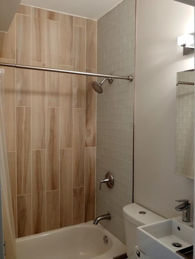 full bathroom with sink, shower / tub combo, and toilet