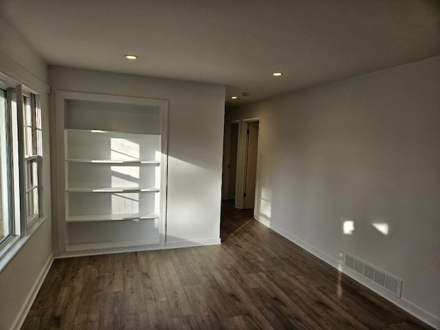 spare room featuring dark wood-type flooring