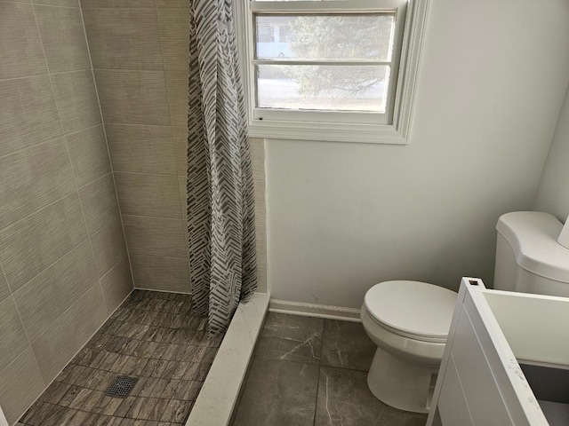 bathroom with walk in shower and toilet