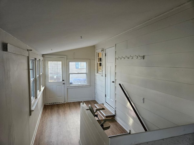 doorway featuring hardwood / wood-style floors and vaulted ceiling