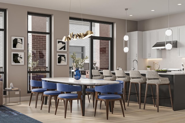 dining space with light wood finished floors and recessed lighting