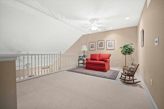 living area featuring ceiling fan, carpet, and vaulted ceiling