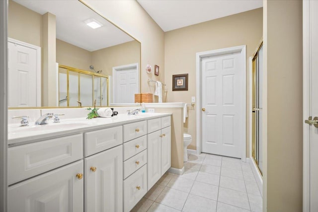 bathroom with walk in shower, vanity, tile patterned flooring, and toilet