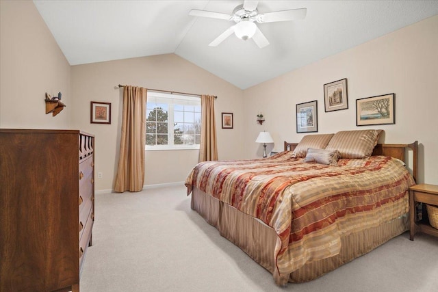 bedroom with vaulted ceiling, ceiling fan, and light colored carpet