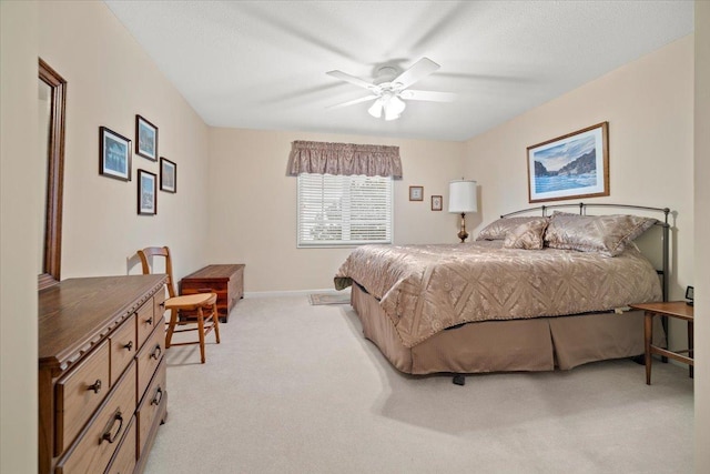 carpeted bedroom featuring a textured ceiling and ceiling fan