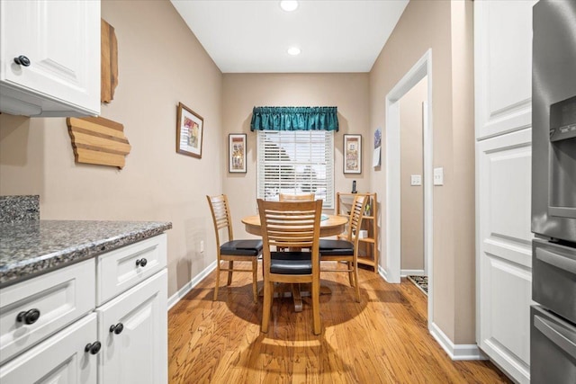 dining space with light wood-type flooring