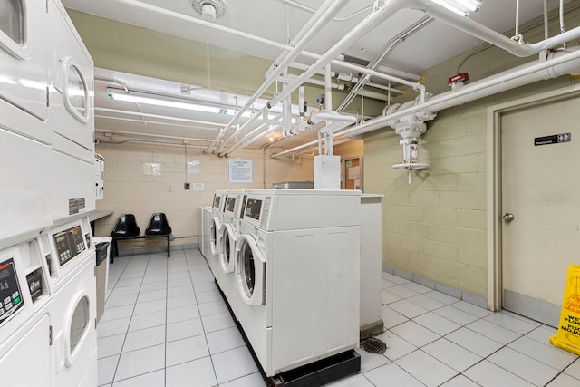 laundry room with washing machine and clothes dryer, light tile patterned floors, and stacked washer and clothes dryer