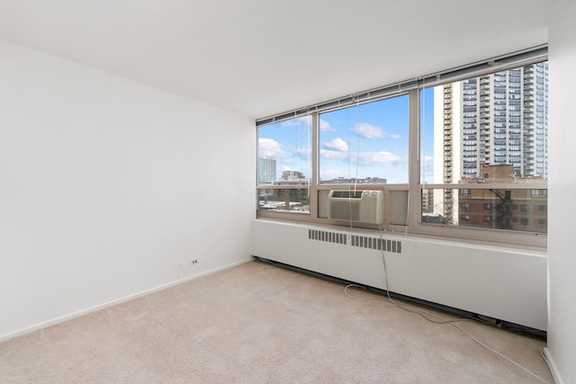 carpeted spare room featuring cooling unit