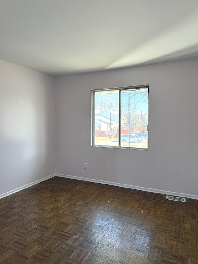 empty room featuring dark parquet floors