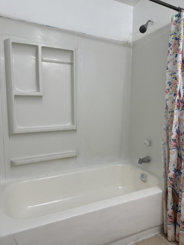 bathroom with shower / bath combo with shower curtain