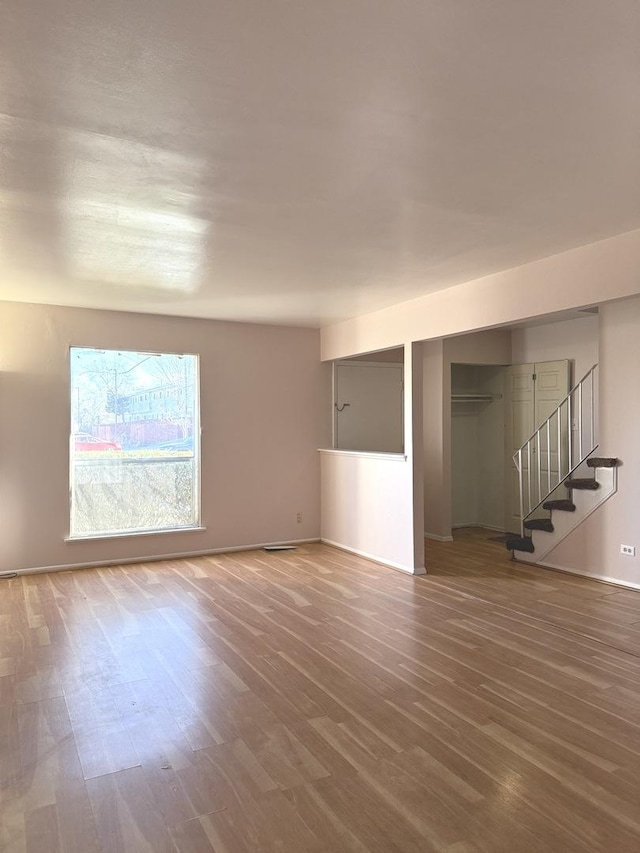 unfurnished room with hardwood / wood-style floors