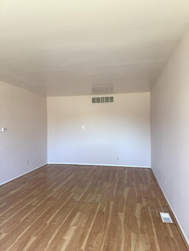 spare room featuring hardwood / wood-style floors