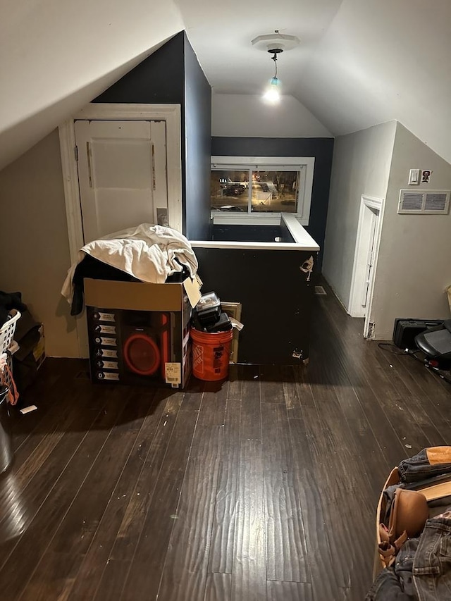 bonus room featuring vaulted ceiling and dark hardwood / wood-style floors