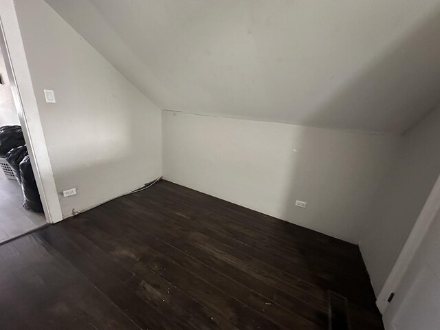 bedroom featuring lofted ceiling and hardwood / wood-style floors