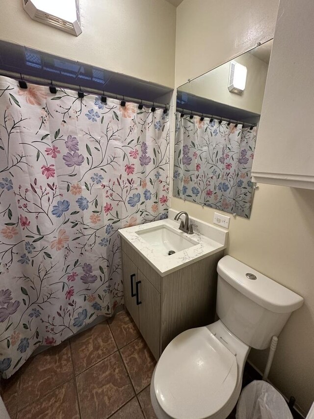 full bathroom with tile patterned flooring, vanity, shower / bath combo, and toilet