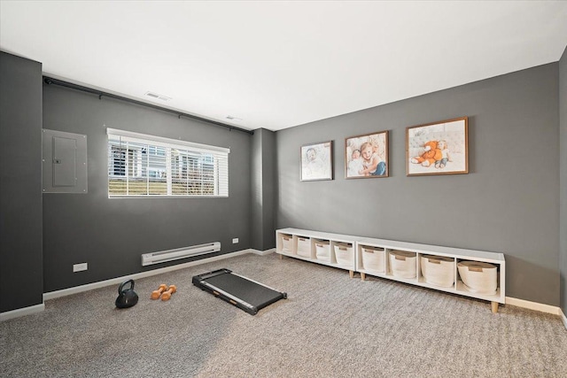 exercise room with electric panel and a baseboard heating unit