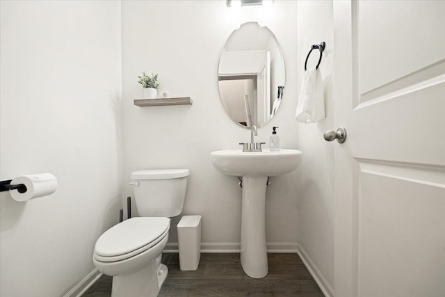 bathroom featuring hardwood / wood-style floors and toilet