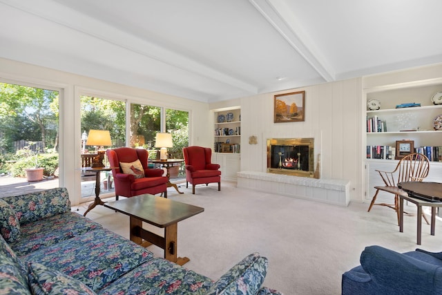 living room featuring beamed ceiling, light carpet, and built in features