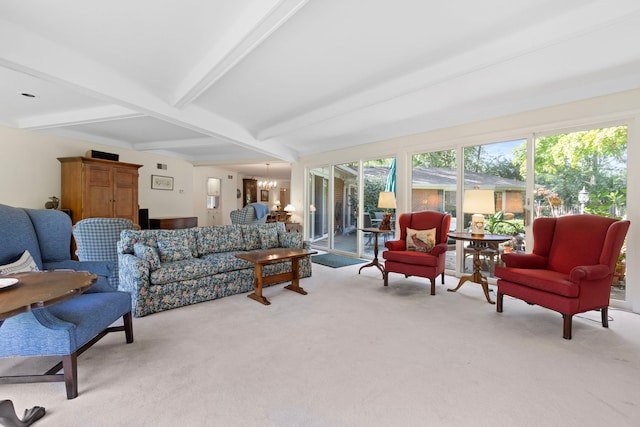 living room with beam ceiling, light carpet, and a notable chandelier