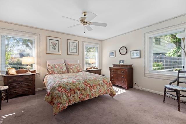 carpeted bedroom featuring ceiling fan and ornamental molding