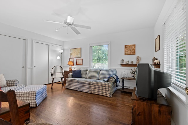 living room featuring dark hardwood / wood-style floors and ceiling fan