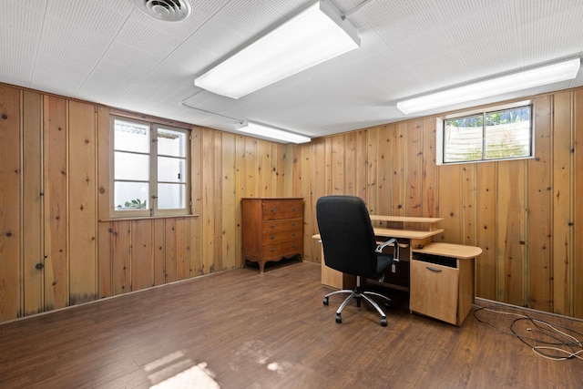 office area with wooden walls and wood-type flooring