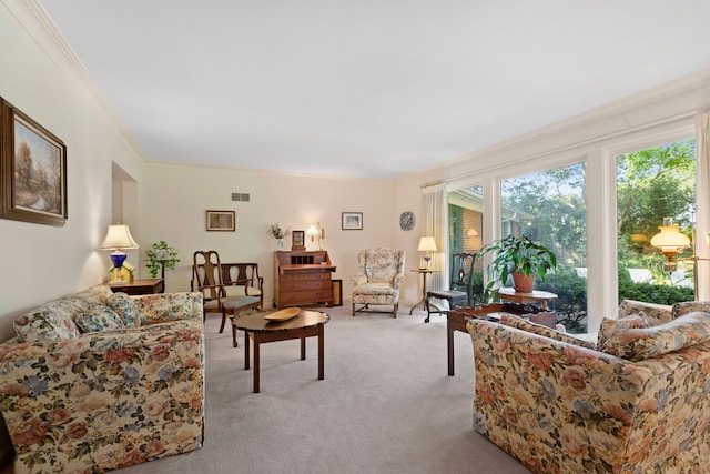 carpeted living room with ornamental molding