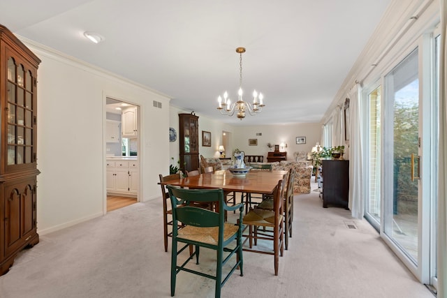 carpeted dining room with ornamental molding and an inviting chandelier