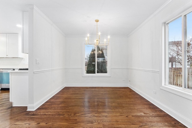 unfurnished dining area featuring dark hardwood / wood-style flooring, crown molding, plenty of natural light, and a notable chandelier