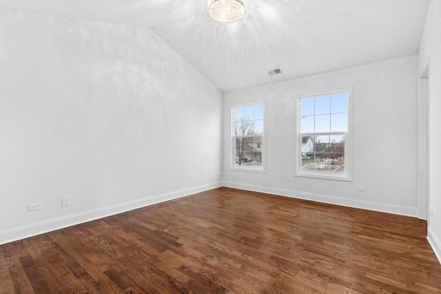 spare room with dark hardwood / wood-style floors and lofted ceiling