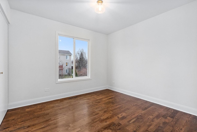 unfurnished room featuring dark hardwood / wood-style flooring