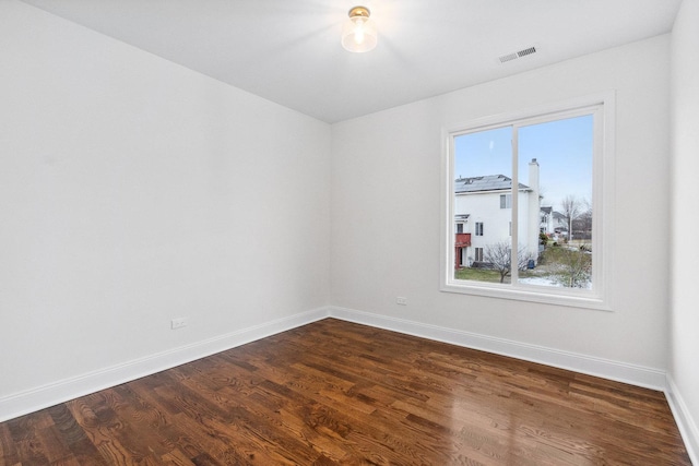 empty room featuring dark wood-type flooring