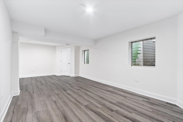 spare room with dark wood-type flooring