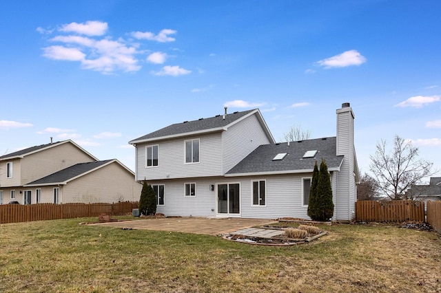 back of property with a patio area and a lawn