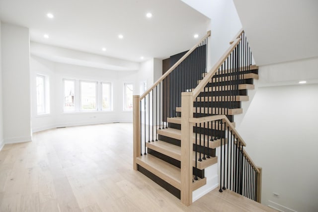 stairs with hardwood / wood-style floors