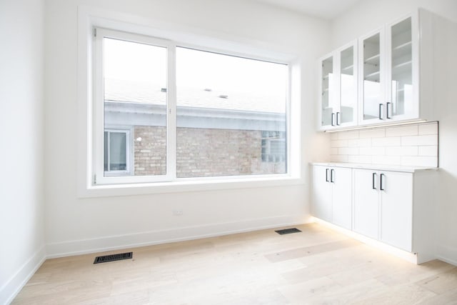 unfurnished dining area with light hardwood / wood-style floors