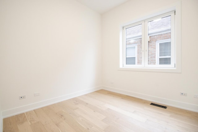 spare room featuring light wood-type flooring