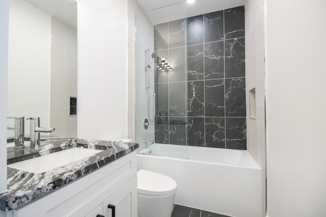 full bathroom featuring tile patterned floors, vanity, toilet, and tiled shower / bath