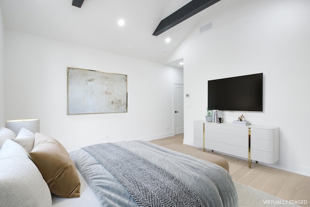 bedroom featuring beamed ceiling, high vaulted ceiling, and light hardwood / wood-style flooring