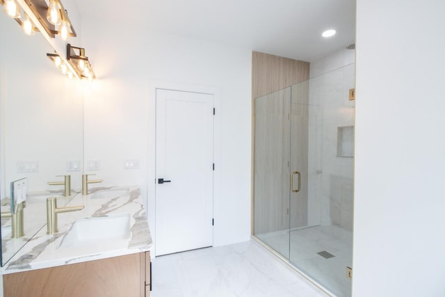 bathroom with vanity and a shower with shower door